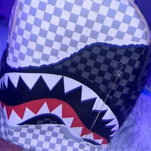 White and black spray ground backpack checkers